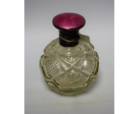 A cut glass scent bottle, hallmarked silver and enamel top