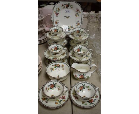 An early 20th century Aynsley tea service for twelve, transfer printed with stylised flowers and birds