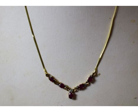A 9ct gold diamond and ruby necklace, boxed
