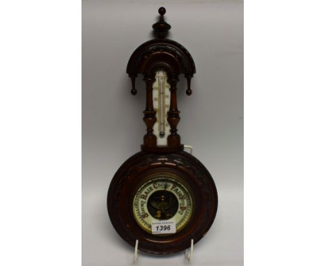 An early 20th century carved mahogany framed aneroid barometer thermometer, cream scales, 40cm high