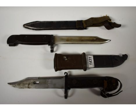 A Polish AKM bayonet and wire cutter, 14.5cm blade, two-piece bakelite grip, scratched numbers TC6772, metal scabbard; anothe