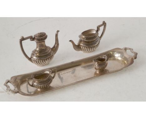 FOUR PIECE MINIATURE SILVER GEORGIAN STYLE TEA SET WITH LONG TWO HANDLED SILVER TRAY, Birmingham 1968, tray 15cm long (teapot