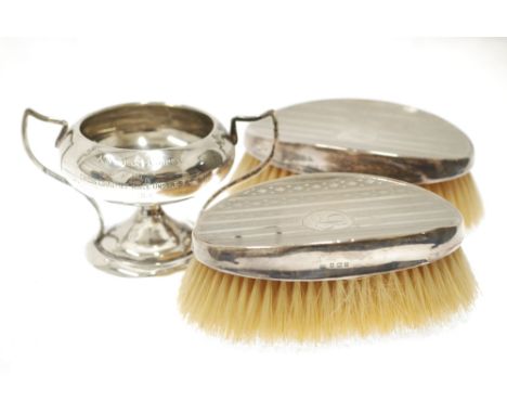 A PAIR OF GENTLEMAN'S  MILITARY HAIR BRUSHES with engine turned silver backs, Birmingham 1910, and a SMALL SILVER TWO HANDLED