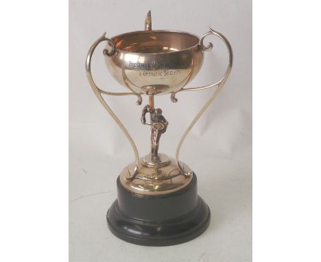 SILVER TENNIS TROPHY CUP, bowl with three double scroll loop supports, above the figure of a tennis player, on domed circular