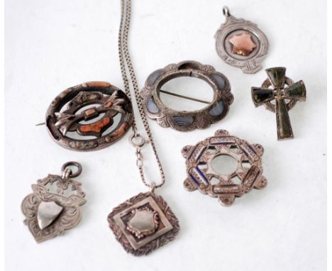 THREE SCOTTISH HARDSTONE PLAID BROOCHES, AN ENAMEL BROOCH AND THREE SILVER MEDALLIONS (7)