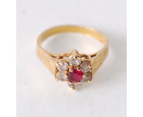 22CT GOLD RED AND WHITE SET GEM CLUSTER RING, central round cut red stone with a cluster surround of six white stones, engrav