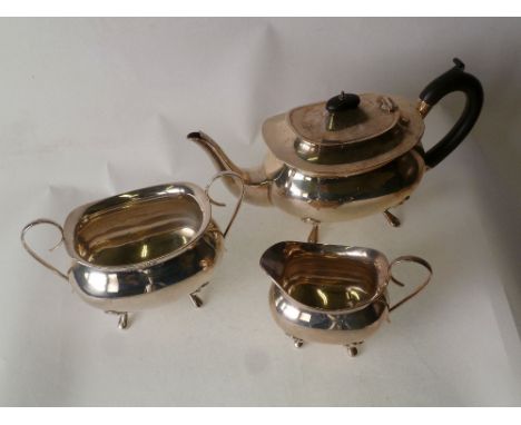 GEORGIAN STYLE THREE PIECE SILVER TEA SET, TEAPOT with blackwood insulator handle and finial, raised on four pad feet, makers