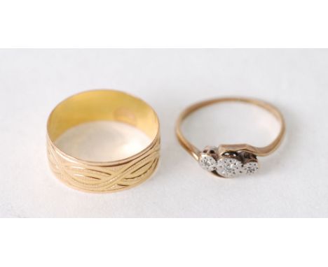 GOLD BROAD WEDDING RING, with chased decoration, stamped 875 (21ct gold), size S ½, 2.7g AND A THREE STONE DIAMOND RING, illu