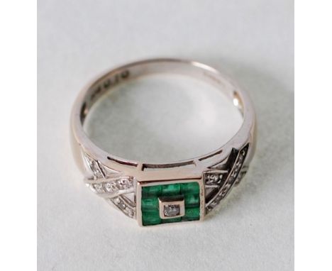 EMERALD AND DIAMOND SET RING, centre set with round brilliant cut diamond, in square bezel setting, with surround of eight sq