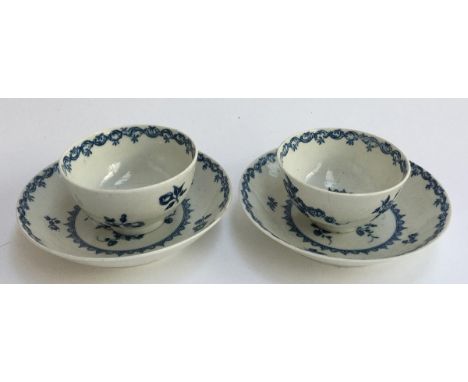 A pair of Worcester tea bowls, 7.5cmD, and saucers 12.5cmD, with blue and white floral pattern (af)