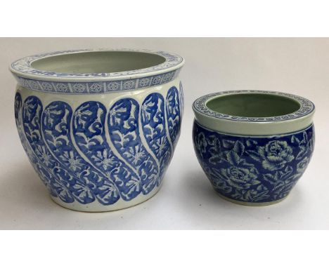 Two Oriental blue and white ceramic planters, the smaller with four character marks to base, 36cmD and 26cmD 