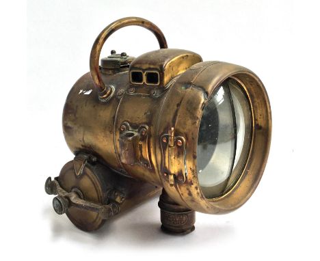 An Edwardian brass self-generating acetylene head lamp, bears warning 'empty water out frequently', 25cmH 