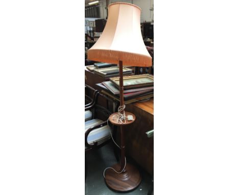 A mahogany turned standard lamp, with turned shelf, and shade