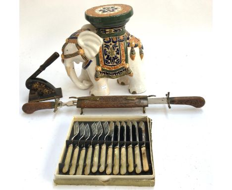 A ceramic elephant, embossing press, canteen of fruit knives and forks, and an unusual carving set 