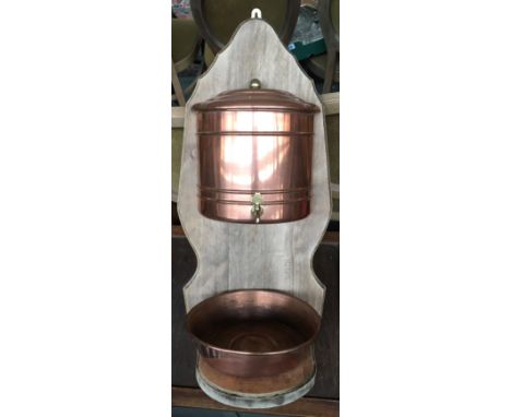 An unusual French copper and oak wall mounted wash basin and reservoir with brass tap 
