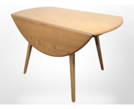 An Ercol elm and beech drop-leaf extending dining table, length 112cm.