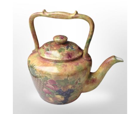 A large transfer-printed teapot decorated with fruit, height 30cm.