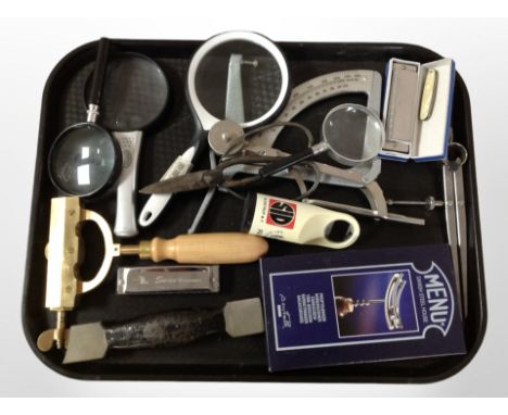 A group of magnifying glasses, harmonicas, boxed corkscrew, scale, etc.