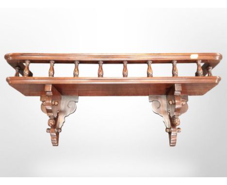 A reproduction mahogany galleried wall shelf, width 79cm.