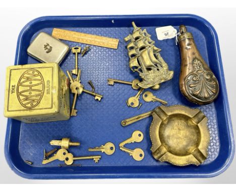 An antique copper powder flask, together with brass door knocker modelled as a ship, keys, cigarette case, Chinese black tea 