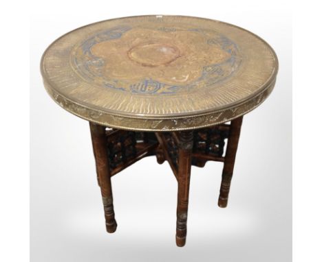 An Indian bobbin turned occasional table with embossed brass top, diameter 60cm.