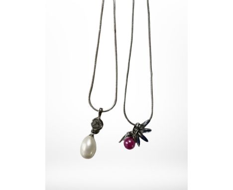 A faux pearl pendant on silver chain, together with a silver fairy and lavender pearl pendant on chain.