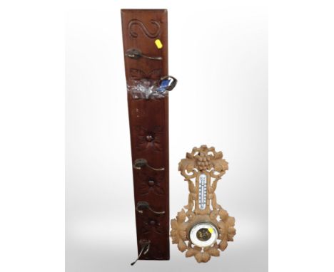 A five-hook coat rack, together with a heavily carved oak barometer.