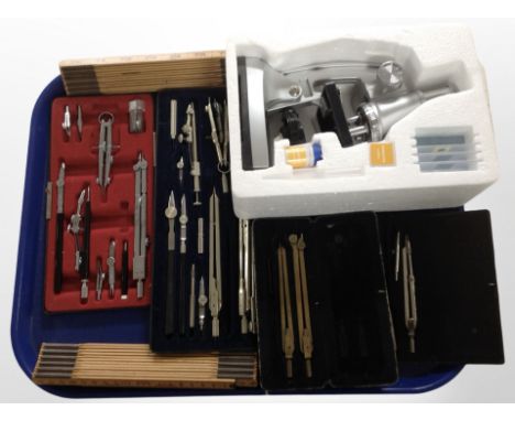 A group of precision drawing instruments, folding rulers, microscope.