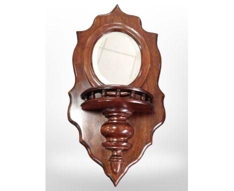 A reproduction mahogany wall mirror with galleried shelf, length 60cm.