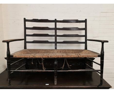 A 1930's 2 seater settee with rush seat and ladder back 