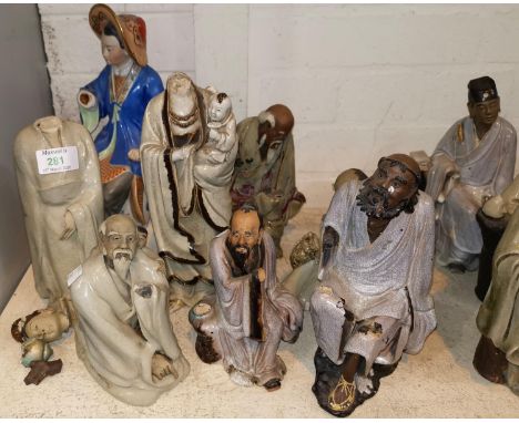 Seven Chinese stoneware figures of sages, sitting and standing, with crackle glaze robes and bisque heads (all with some dama