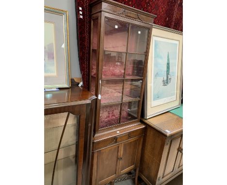 An Edwardian full height thin display cabinet with glazed top cupboard and door bellow (one back leg missing) 