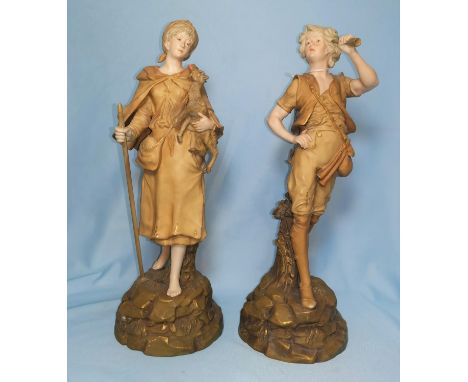 A pair of 19th century Turnwein figures, man with horn and woman carrying a kid, height 34cm (woman stick, hand and man horn 