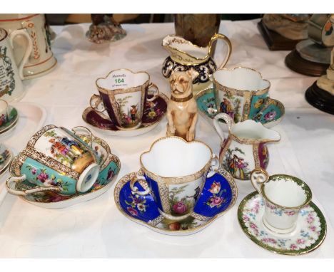 A pair of late Meissen porcelain loving cups with saucers, Augustus Rex; a similar Dresden pair (1 cup a.f.); a porcelain fig