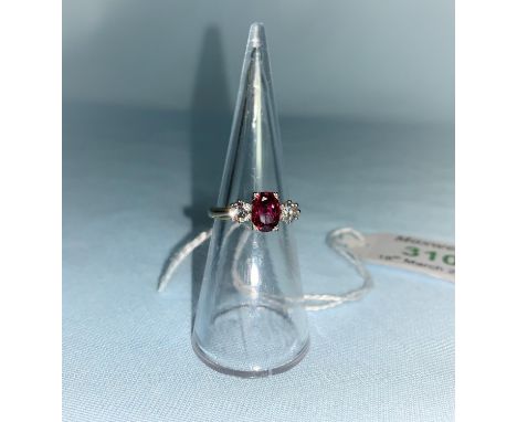 A yellow metal dress ring set cushion cut ruby coloured stone flanked by 2 brilliant cut diamonds 