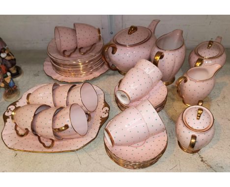 A 1930's Carltonware 43 piece tea set, turquoise jewelling on a pink ground with gilt borders 