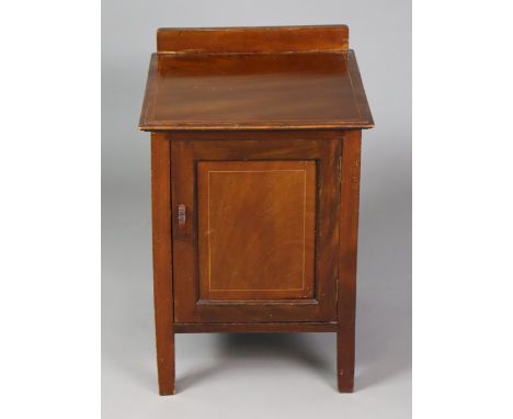 An Edwardian inlaid-mahogany pot cupboard fitted with a centre shelf enclosed by a panel door, &amp; on short square legs, 45