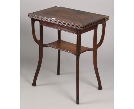 A 19th century oak card table inset green baize to the rectangular fold-over top, &amp; on four shaped legs with an open unde
