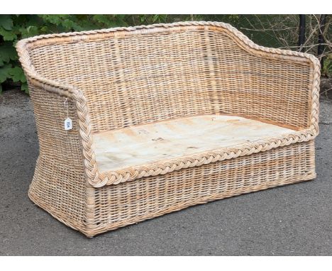 A vintage wicker &amp; bamboo two-seater conservatory sofa (lacking seat cushion), 136cm wide x 72cm high x 90cm deep.