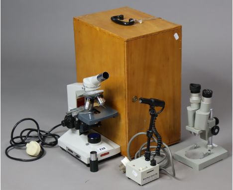 A Chinese “XSZ-109” microscope, cased; a student’s microscope, uncased; &amp; a micro power laboratory lamp.