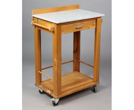A pine kitchen island with a grey marble rectangular top, fitted with a frieze drawer above an adjustable shelf, on square le