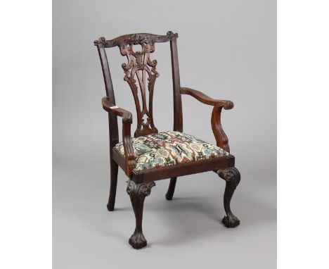 A Chippendale-style child’s elbow chair with a pierced splat back, padded drop-in-seat, &amp; on carved cabriole legs &amp; c