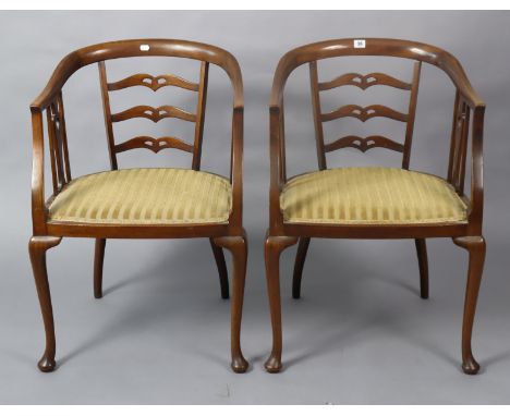 A pair of mahogany tub-shaped chairs each with a pierced ladder-back, padded seat, &amp; on slender cabriole legs.