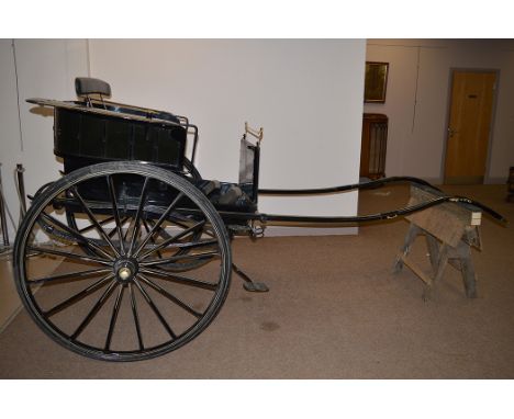 A late Victorian round back gig by Mills of Paddington, reconditioned and painted black with cream lining, fitted sixteen spo