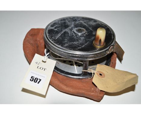 A vintage alloy 4 1/2in. salmon fly reel, horn winding handle, plain brass foot and rim tensioning knob; and a leather drawst