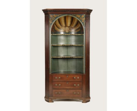 AN EARLY GEORGE III MAHOGANY STANDING CORNER CUPBOARD with a carved and dentilled cornice over a pair of panelled doors (now 