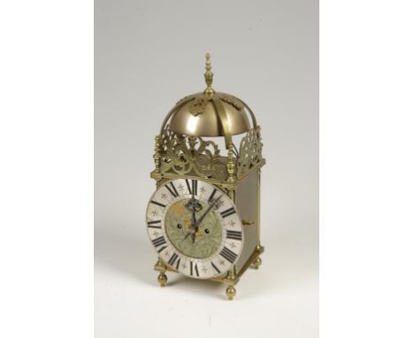 AFTER NATHANIEL HEDGE, COLCHESTER: A LANTERN STYLE WALL CLOCK, with pierced brass bell top, 16" high. See illustration.