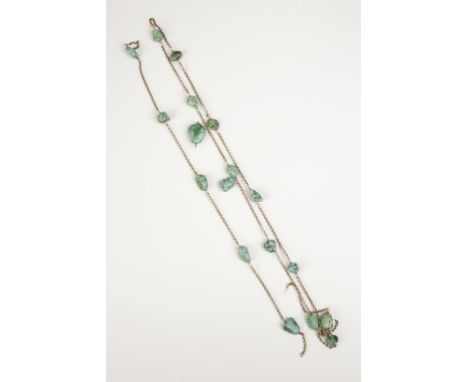 A BOULDER TURQUOISE LONG NECKLACE, the unmarked yellow gold chain interspersed with drilled boulder turquoise beads (some loo