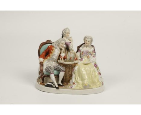 A MEISSEN STYLE PORCELAIN FIGURAL GROUP, 'The chess players', a lady and gentleman seated playing chess with a girl looking o