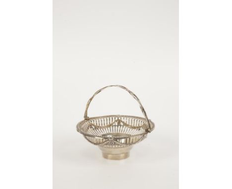 A GEORGE III IRISH EPERGNE BASKET of circular tapering form, with a pierced swing handle and slat pierced body lined with swa